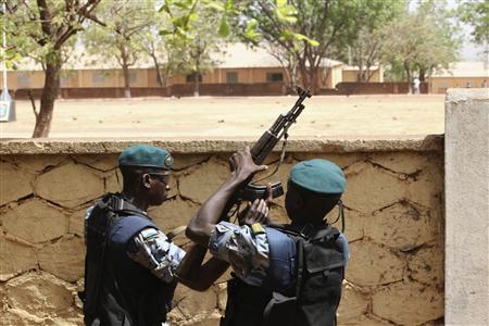 Malian junta soldiers stand guard at their headquarters in Kati, outside Mali's capital Bamako