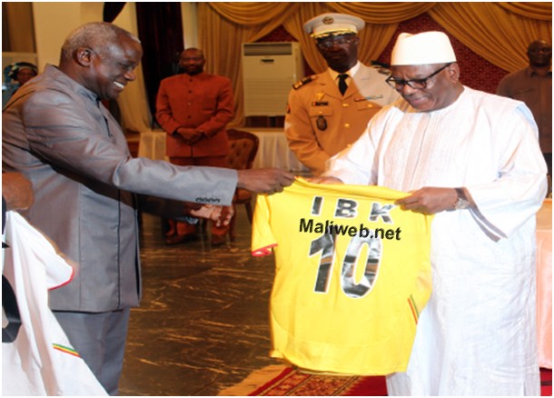 Le président de la République recevant son maillot avec le président de la Femafoot