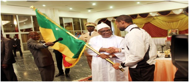 Le capitaine des Aigles du Mali, Seydou Keita recevant  des mains du chef de l'Etat, IBK , le drapeau national