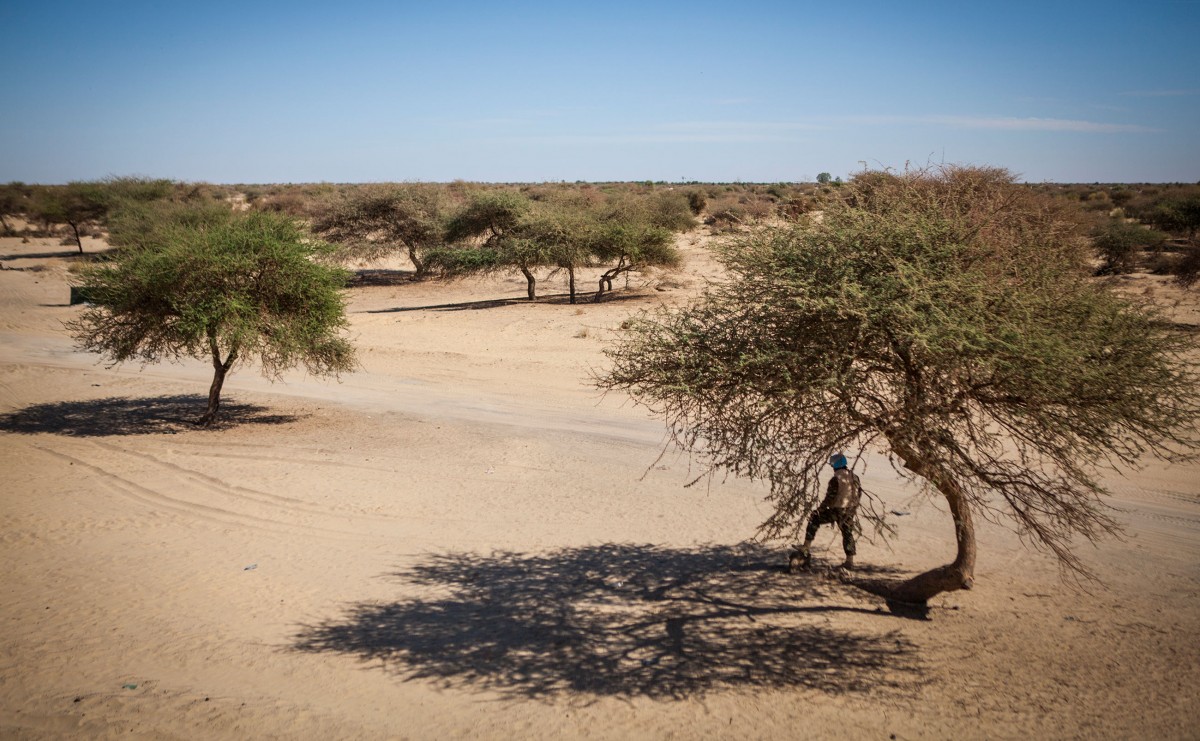 A U.N. peacekeeper stands near a FAMA (Armed Forces of Mali) checkpoint on the outskirts of Timbuktu.