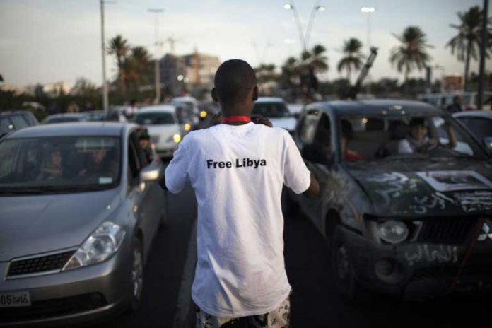 Un jeune libyen dans les rues de Tripoli, après l'annonce de la capture et de la mort de Mouammar Kadhafi, le 20 octobre 2011 / © AFP/Archives / MARCO LONGARI