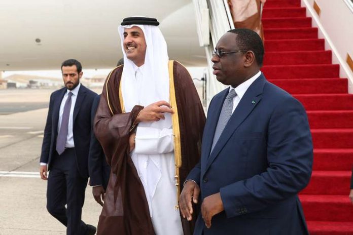 SENEGAL-QATAR-DIPLOMACY-POLITICS Le président sénégalais Macky Sall accueille l’émir du Qatar, Tamim Ben Hamad Al-Thani, à son arrivée à Dakar, première étape de sa tournée en Afrique de l’Ouest, le 20 décembre 2017. CRÉDITS : HANDOUT / AFP