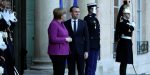 French President Emmanuel Macron welcomes German Chancellor Angela Merkel as she arrives for a meeting at the Elysee Palace in Paris